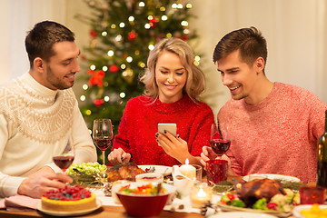 Image showing friends with cellphone celebrate christmas at home