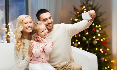 Image showing family taking selfie by smartphone on christmas