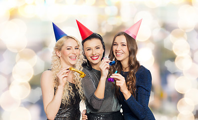 Image showing happy women with party caps hugging