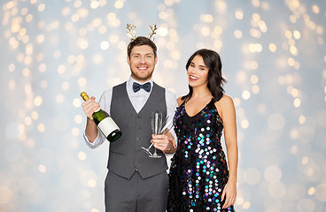 Image showing couple with champagne bottle at christmas party