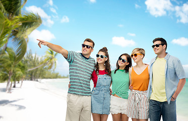 Image showing friends in sunglasses over exotic beach background