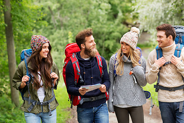 Image showing friends or travelers hiking with backpacks and map