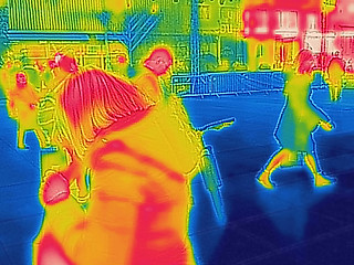 Image showing Infrared Thermal image of people walking the city streets on a c