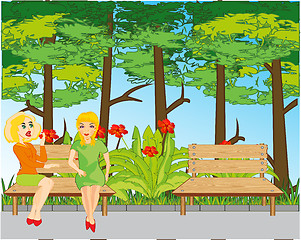 Image showing Two girls talk on bench in park