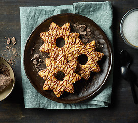 Image showing freshly baked cookies decorated with chocolate and sugar