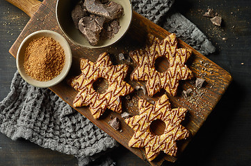 Image showing freshly baked cookies decorated with chocolate and sugar