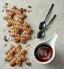 Image showing chocolate sauce and star shaped cookies