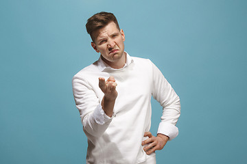 Image showing The overbearing businessman point you and want you, half length closeup portrait on blue background.