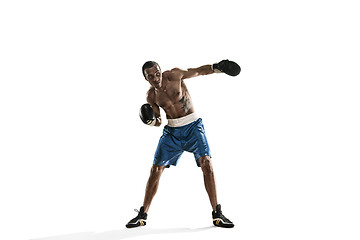 Image showing Sporty man during boxing exercise making hit. Photo of boxer on white background