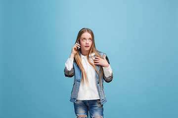 Image showing Beautiful teen girl looking suprised isolated on blue