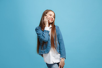 Image showing Beautiful teen girl looking suprised isolated on blue