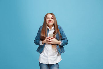 Image showing Beautiful teen girl looking suprised isolated on blue