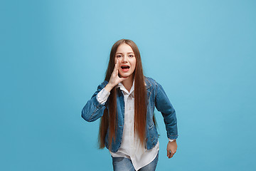 Image showing Isolated on pink young casual teen girl shouting at studio