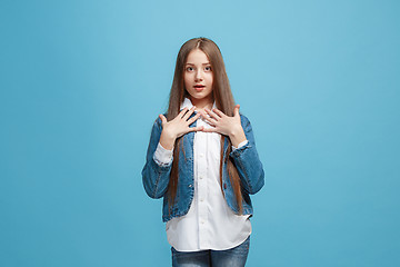 Image showing Beautiful teen girl looking suprised isolated on blue