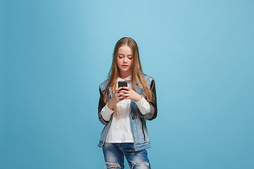 Image showing Beautiful teen girl looking suprised isolated on blue