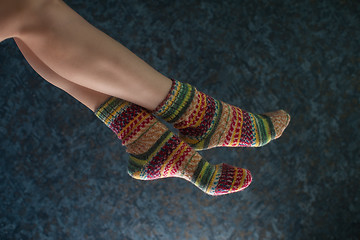 Image showing Woman legs in wool knitted socks