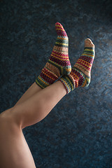 Image showing Woman legs in wool knitted socks