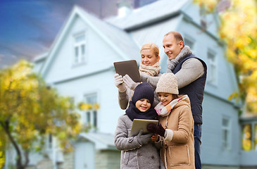 Image showing family with tablet pc over living house in autumn