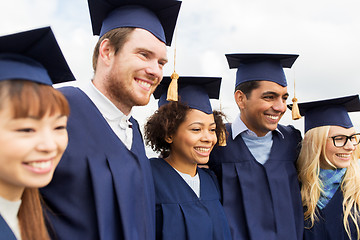 Image showing happy students or bachelors in mortar boards