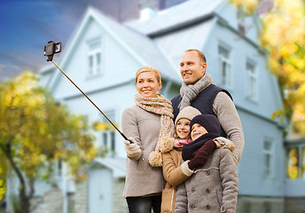 Image showing family takes autumn selfie by cellphone over house