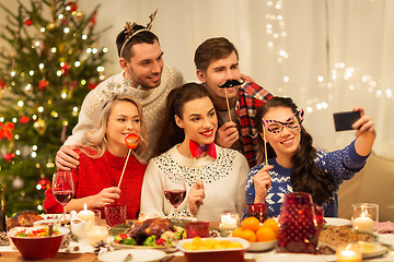 Image showing friends taking selfie at christmas dinner