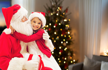 Image showing girl hugging santa at home on christmas