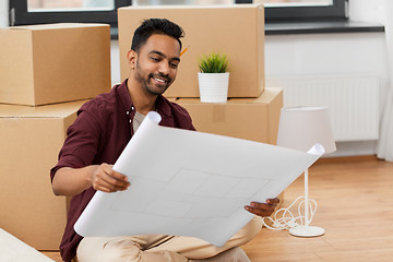 Image showing man with blueprint and boxes moving to new home