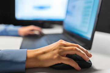 Image showing close up of female hand using computer mouse