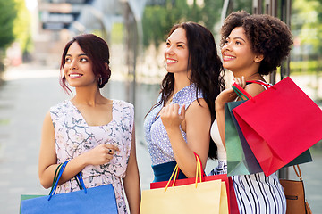 Image showing happy women with shopping bags in city