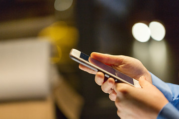 Image showing close up of businesswoman hands with smartphone