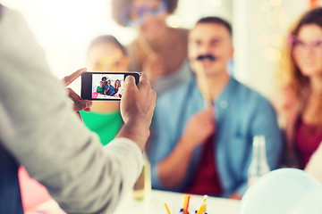 Image showing friends or coworkers photographing at office party