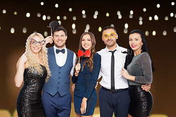 Image showing happy friends with party props posing