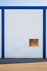 Image showing White Industrial warehouse wall in blue frame.