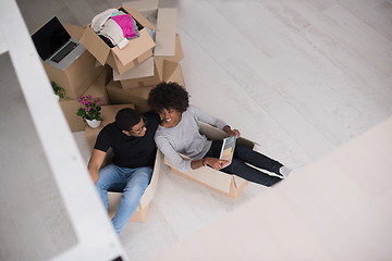 Image showing African American couple  playing with packing material