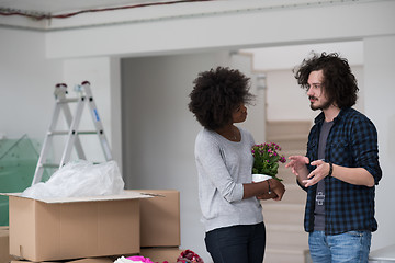 Image showing multiethnic couple moving into a new home