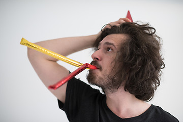 Image showing Portrait of a man in party hat blowing in whistle