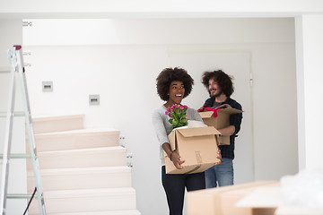 Image showing multiethnic couple moving into a new home