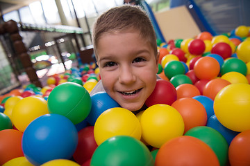 Image showing Young mom with her kids in a children\'s playroom