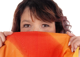 Image showing Woman holding scarf over mouths