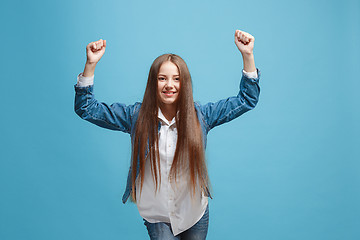 Image showing Happy success teen girl celebrating being a winner. Dynamic energetic image of female model