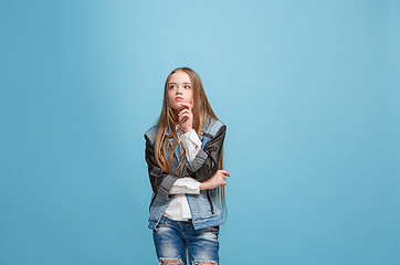 Image showing Young serious thoughtful teen girl. Doubt concept.