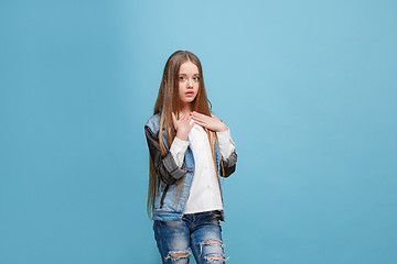 Image showing Beautiful teen girl looking suprised isolated on blue