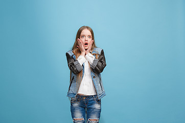 Image showing Beautiful teen girl looking suprised isolated on blue