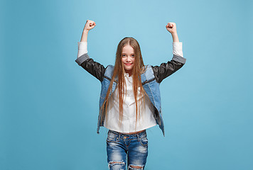 Image showing Happy success teen girl celebrating being a winner. Dynamic energetic image of female model