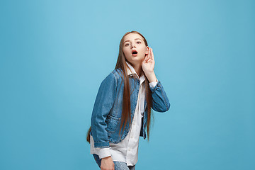 Image showing The happy teel girl standing and listening