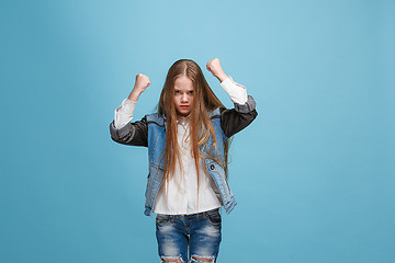 Image showing Portrait of an angry woman looking at camera isolated on a blue background