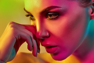 Image showing High Fashion model woman in colorful bright lights posing in studio