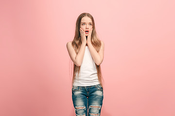 Image showing Beautiful teen girl looking suprised isolated on pink