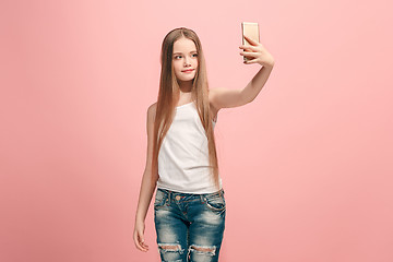 Image showing The happy teen girl making selfie photo by mobile phone