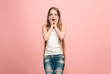 Image showing Beautiful teen girl looking suprised isolated on pink